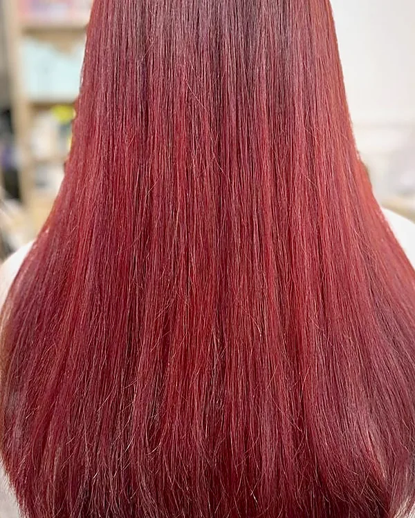 The same hair after re-colouring to an even burgundy