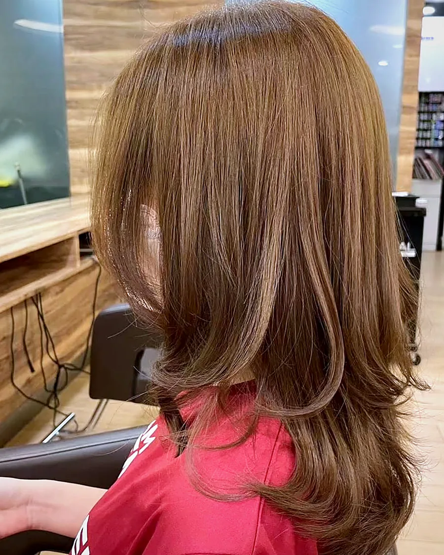 The same hair after a layered cut, with movement through the ends
